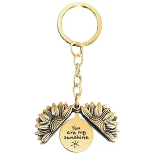 Detail of opening sunflower keychain with hidden You are my sunshine engraving