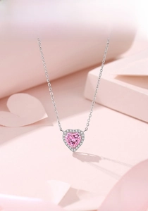Close-up of S925 silver necklace featuring a pink heart pendant with white zircon halo