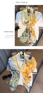 Detailed view of yellow and grey floral silk shawl styled with accessories