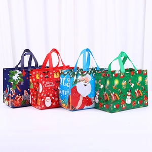Detailed view of four colorful Christmas non-woven gift bags with festive holiday prints