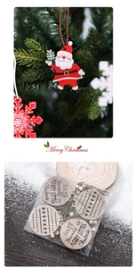 Close-up of wooden Christmas tree ornaments with Santa and snowflake designs