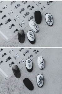 Close-up of retro black and white rose nail stickers on various polish base colors