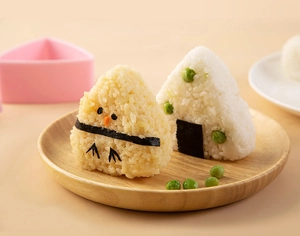 Close-up of cute chick-shaped and triangle rice balls made with onigiri sushi molds
