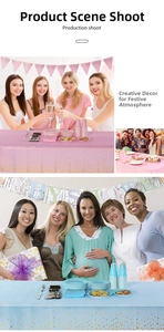 Close-up of pink and blue party set with polka dot tablecloth and baby shower banner