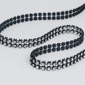Detail of double row silver rhinestones on black fabric trim for DIY craft projects