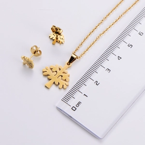 Detail view of gold Christmas tree necklace and earrings set with scale measurement