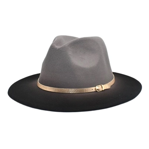 Detail of grey and black two-tone fedora hat with a gold buckle leather strap band