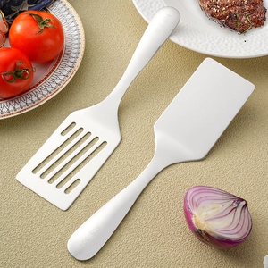 SUS 304 stainless steel spatula and slotted turner for steak on a textured tabletop