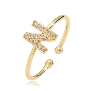 Detailed close-up of golden open ring featuring a sparkling cubic zirconia letter Z