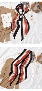 Detail of a vintage French silk scarf featuring classic black, red, and white vertical stripes