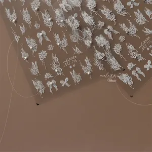 Detailed 3D embossed nail stickers featuring white roses, bows and crystals on MS-715 sheets