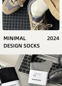 Detail view of minimalist cotton crew socks in neutral tones with modern lifestyle packaging
