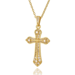 Detailed close-up of golden cross necklace with shimmering cubic zirconia micro-pave