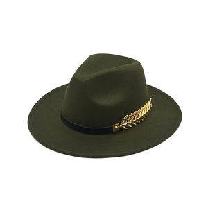 Detailed close-up of dark green wool felt hat with gold feather accessory and ribbon