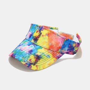 Detail view of colorful tie-dye visor hat showing adjustable velcro strap and stitched brim