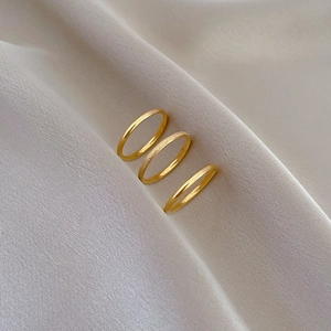 Three-piece gold titanium steel ring set with matte sandblasted and mirror polished finishes
