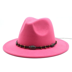 Detail of bright pink fedora wool hat with bohemian turquoise and gold beaded band