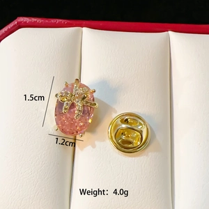 Detail of pink crystal butterfly pin with measurements 1.5cm by 1.2cm and 4.0g weight