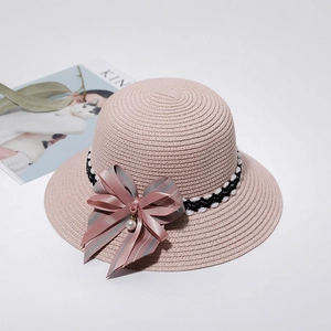 Elegant pink straw sun hat with striped bow ribbon and pearl for summer vacation