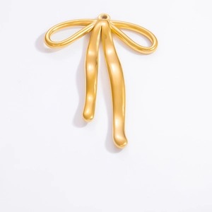 Macro shot of 18k gold butterfly bow pendant showing smooth metallic finish and shine