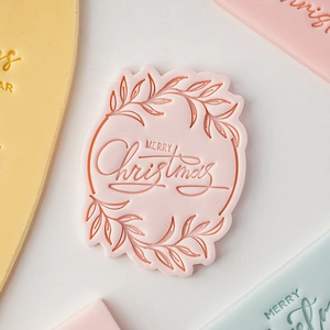 Pink Merry Christmas fondant stamp with leaf patterns for festive cookie baking tool