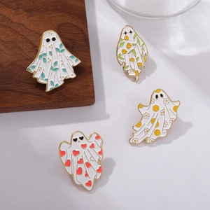 Set of four cute white ghost enamel pins with colorful patterns on wood background