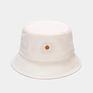 Detailed view of white cotton bucket hat featuring embroidered daisy and clean stitching