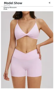 Detail of cherry pink yoga set featuring thin straps sports bra and cross waist shorts