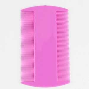 Close-up of pink double-sided fine-tooth flea comb for pet grooming and cleaning