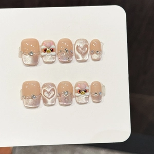 Press-on nail set featuring milk tea cat eye effect with 3D lion heart and pearls