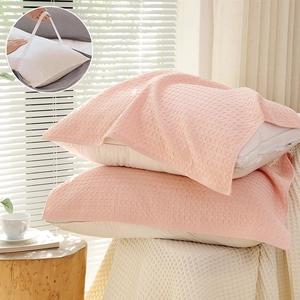 Pink waffle cotton pillow towels with elastic straps shown in a cozy bedroom setting