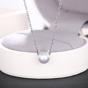 Detailed close-up of a cat ear pearl pendant necklace with shimmering zircon accents