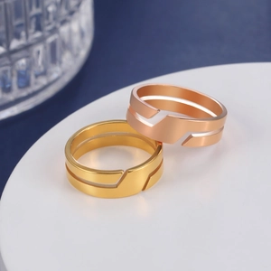 Polished gold and rose gold stainless steel couple rings with geometric hollowed design