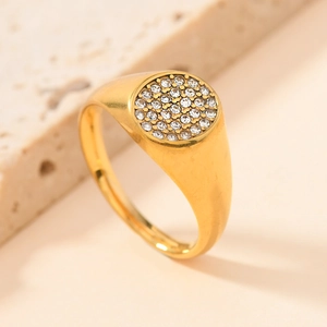 Macro detail of gold signet ring with micro-pave diamond setting on stone pedestal