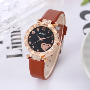 Close-up of rose gold watch case with crystal bezel and brown leather strap details