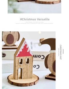 Detail of wooden Christmas house and penguin ornament on natural wood base