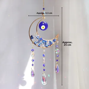 Detailed view of moon suncatcher with evil eye bead and crystal prism rainbows