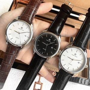 Three quartz watches with leather straps held over a wooden box for men