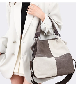 Detail of high-capacity canvas tote bag featuring beige and dark coffee color blocking