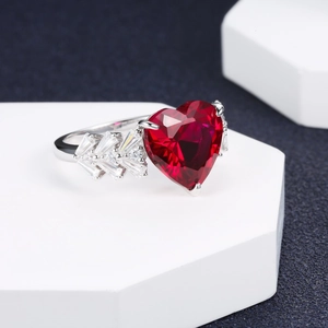 S925 sterling silver ring with a large heart-shaped red gemstone on a white pedestal