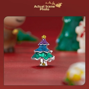 Macro detail of S925 silver Christmas tree charm with colorful enamel layers and motifs