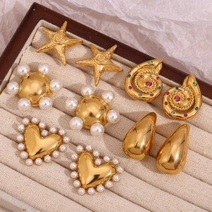 Assorted 18K gold plated heart and snail earrings with pearls in a jewelry tray