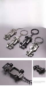 Detailed close-up showing alloy F1 racing car keychain wheels and streamlined car body structure