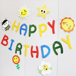 Close-up of colorful Happy Birthday banner with paper sun, star, bee and flower cutouts