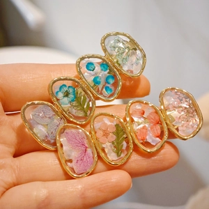 Handmade clear resin hair clips with real dried flowers and golden metallic frames