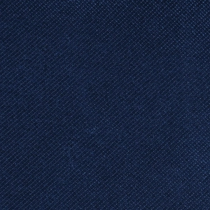 Macro shot of high-density navy blue twill fabric with subtle satin sheen and fine texture