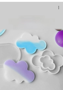 Close-up of cloud and oval silicone molds for DIY resin coasters with gradient art