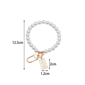 Detail showing pearl keychain with Elizabeth II coin pendant and lobster clasp size data