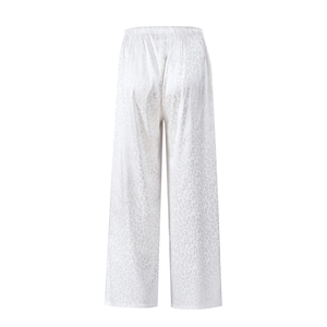 Detail view showing back of white satin wide-leg pants with leopard jacquard texture
