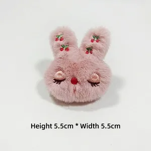 Detail of pink plush bunny accessory with cherry embroidery, sized 5.5cm x 5.5cm